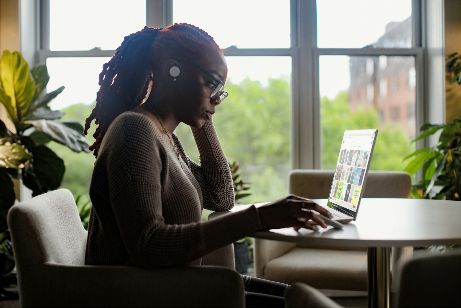 Black woman comfortably connecting with care online